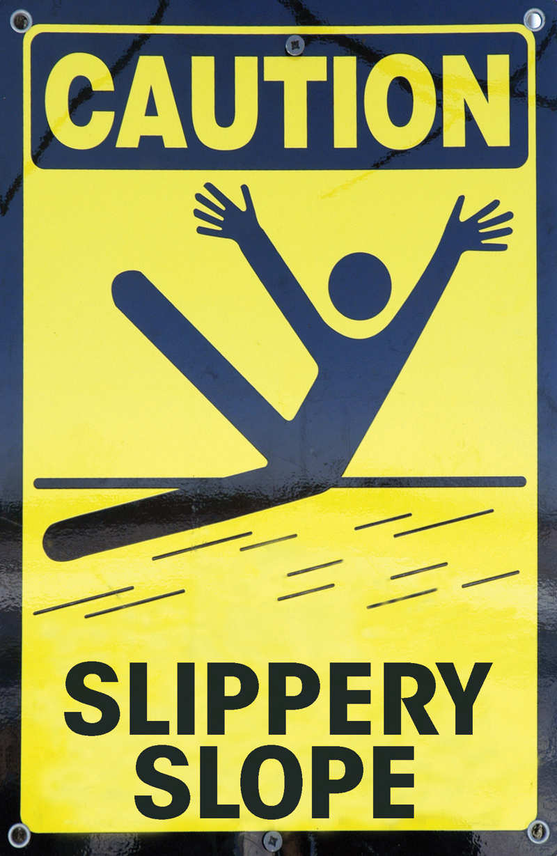 The image shows a yellow sign board reads, ‘CAUTION-A SLIPPERY SLOPE’. The sign board shows the symbol of slippery slope, in which a man is seen slipping on the road.