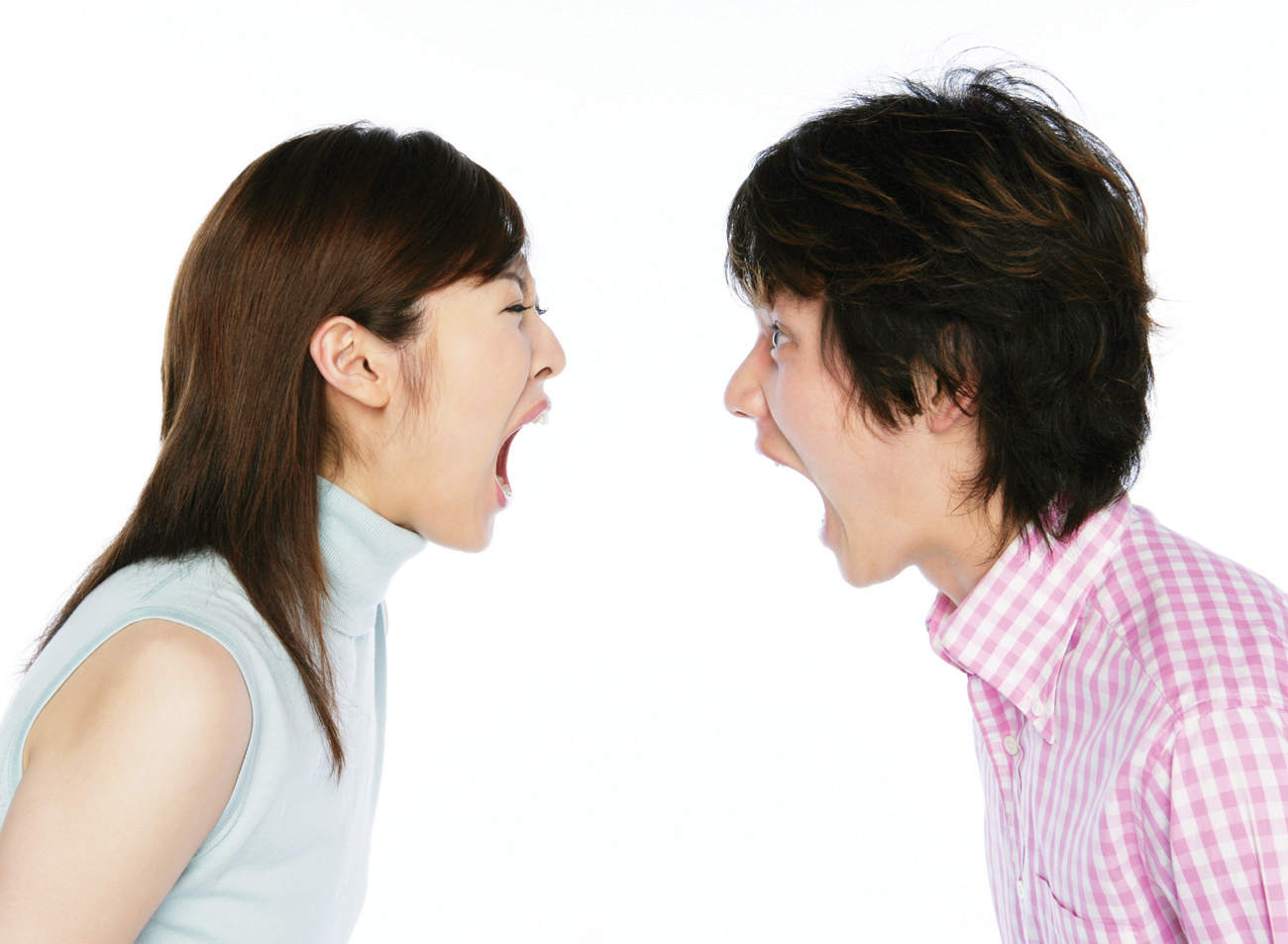 A man and a woman facing and shouting at each other with mouths open to the fullest